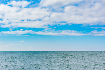 Sky over the calm surface of the sea at day time.の写真素材