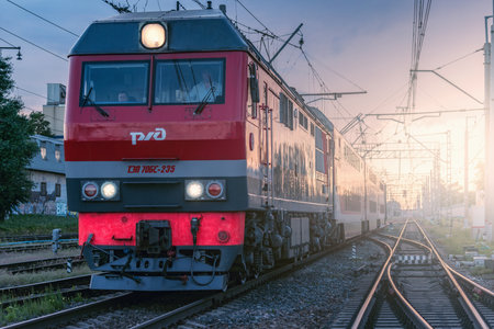 Moscow, Russia - June 03, 2019: Passenger train departs from the station at sunset time.のeditorial素材