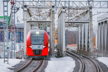 Highspeed train moves through the bridge at winter day.の写真素材