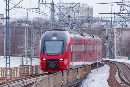 Express train to Sheremetyevo airport approaches to the station platform at winter sunset. Moscow. Russia.の写真素材