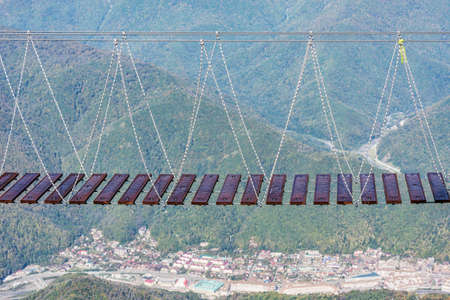 Rope bridge above the deep gorge. Caucasus. Russia.の写真素材