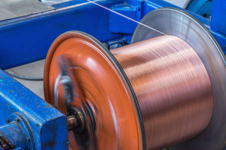 Metal wire spool spins on the machine.の写真素材