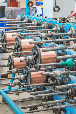 Metal wire spools spin on the machine.の写真素材