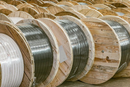 Large wooden spools with cable inside of the plant storage.の写真素材