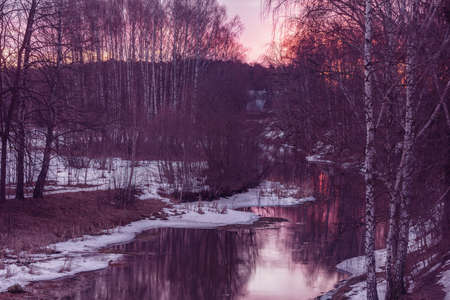 Small creek at early spring sunset time.