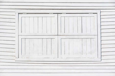 Closed window of the wooden small building.