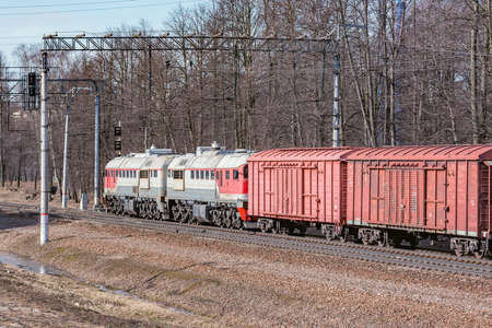 Long freight train approaches to the station.の写真素材