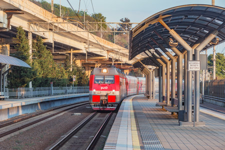 Sochi, Russia - April 22, 2021: Passenger train to Saratov arrives to the Khosta station platform.のeditorial素材