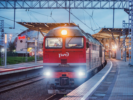 Sochi, Russia - April 13, 2021: Passenger train from Sukhum to Moscow stands by the station platform of Imeretian resort - Olympic park.のeditorial素材