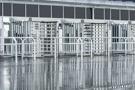 Turnstiles with electronic card readers by the soccer stadium.