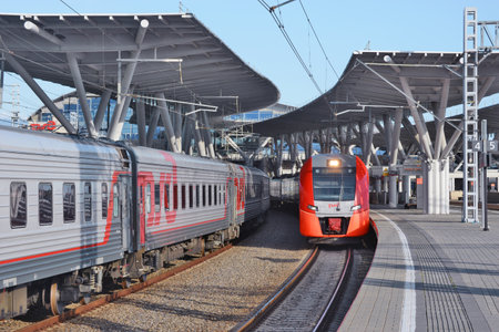 Sochi, Russia - April 14, 2021: Passenger trains stand by the station platform of Imeretian resort - Olympic park.のeditorial素材