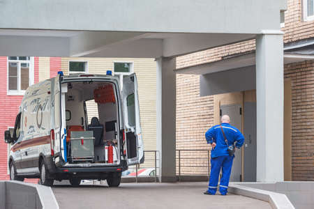 Ambulance car stands by the hospital entrance.の写真素材