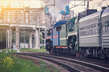 Retro steam train on city background. Moscow. Russia.の写真素材