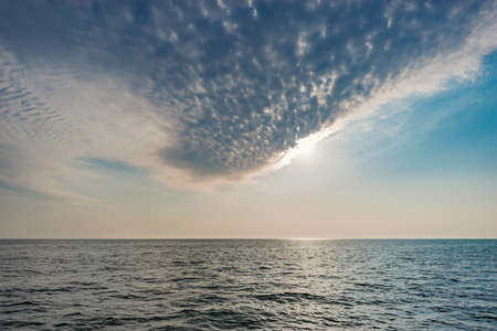 Amazing sunset sky above the ocean surface.の写真素材