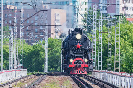 Retro train moves on the city background. Moscow. Russia.の写真素材