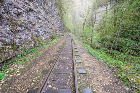 Narrow gauge railway in the deep narrow Guam canyon. Western Caucasus. Russia.の写真素材