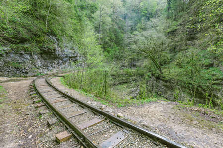 Narrow gauge railway in the deep narrow Guam canyon. Western Caucasus. Russia.の写真素材