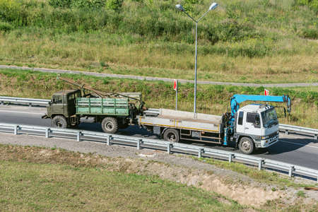 Tow truck moves the old broken car.の写真素材