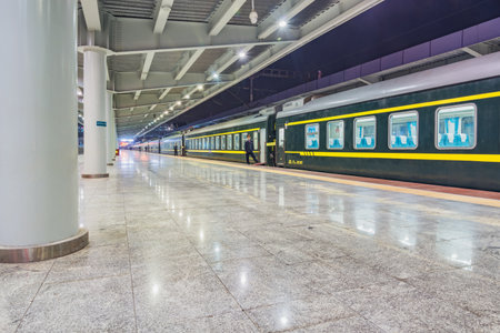Guilin, China - December 05, 2016: Passenger train stands by the platform at evening timeのeditorial素材