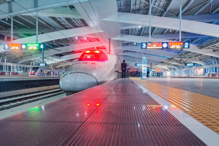Zhuhai, China - December 20, 2016: Passenger highspeed train stands by the platform at evening time.のeditorial素材