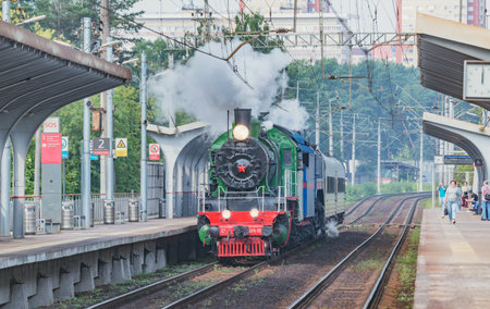 Moscow region, Russia - August 07, 2021: Retro train departs from the platform.のeditorial素材