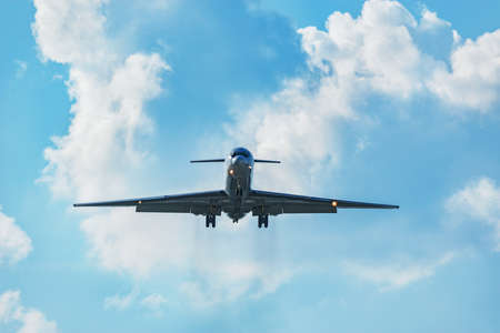 Flight of the retro passenger plane at cloudy day.の写真素材