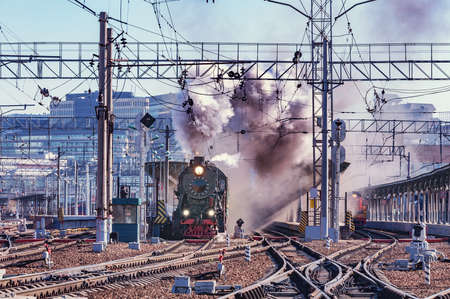 Retro train departs from the platform. Moscow. Russia.