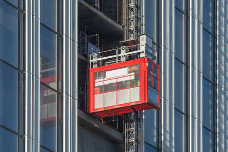 Elevator for workers moves to the building top.の写真素材