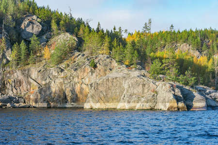 Trees on the cliffs of Lake Ladoga at autumn evening. Republic of Karelia. Russia.の写真素材