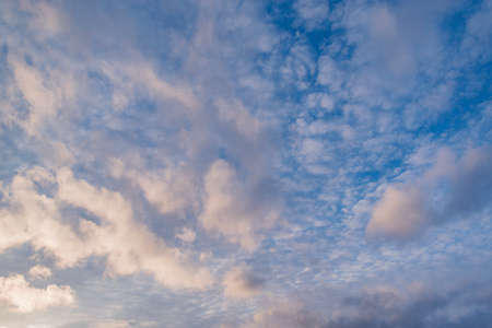 Clouds on the blue sky. Cloudscape at sunset time.の写真素材