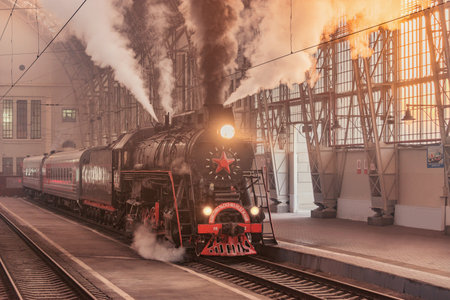 Moscow, Russia - October 09, 2021: Retro steam train departs from the station at morning time.のeditorial素材