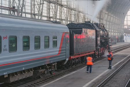 Moscow, Russia - October 09, 2021: Retro steam train departs from the station at morning time.のeditorial素材