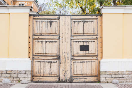 Ancient wooden gate by the private house.の写真素材