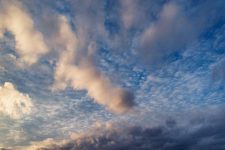 Clouds on the blue sky. Cloudscape at sunset time.の写真素材