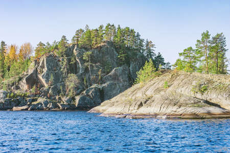 Trees on the cliffs of Lake Ladoga at autumn evening. Republic of Karelia. Russia.の写真素材