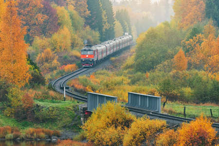 Passenger train moves along at autumn morning. Karelia. Russia.の写真素材