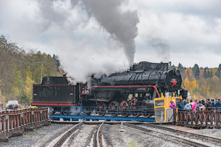 Ruskeala, Russia - October 01, 2021: Retro steam locomotive at the turning circle. Ruskeala Mountain Park railway station.のeditorial素材