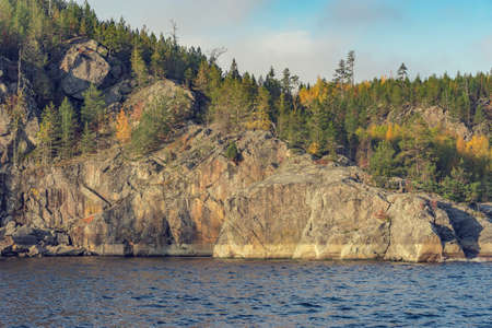 Trees on the cliffs of Lake Ladoga at autumn evening. Republic of Karelia. Russia.の写真素材