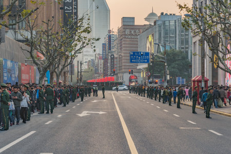 Shanghai, China - December 31, 2016: Crowd of people and army patrol on the central city street before New Year day.のeditorial素材