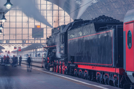 Moscow, Russia - October 09, 2021: Retro steam train departs from the station at morning time.のeditorial素材
