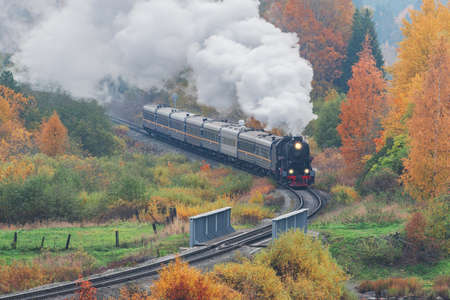 Retro steam train moves at autumn morning. Karelia. Russia.の写真素材