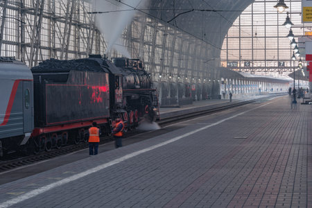 Moscow, Russia - October 09, 2021: Retro steam train departs from the station at morning time.のeditorial素材