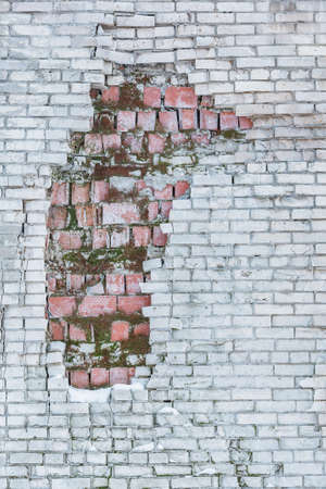 Damaged white and red brick wall background outside of the building.の写真素材