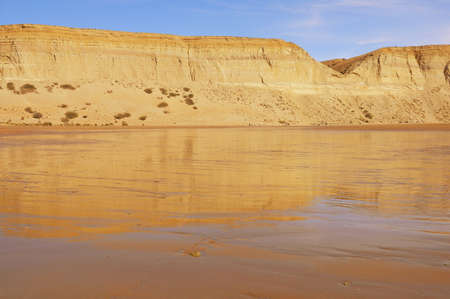 Cliffs by the beach of Pacific ocean. Puerto Santa Cruz. Argentina.