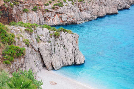 Colorful cliffs by the water edge. Natural reserve Zingaro. Sicily. Italy.の写真素材