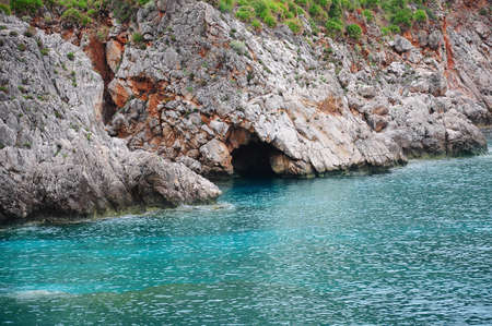 Colorful cliffs by the water edge. Natural reserve Zingaro. Sicily. Italy.の写真素材