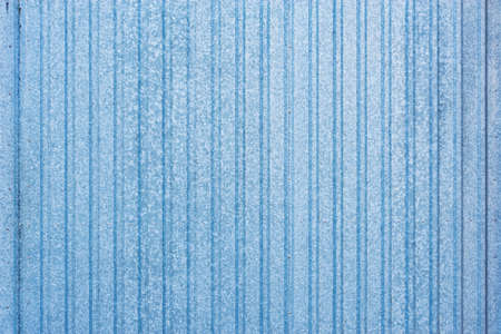 White and blue corrugated metal fence background.の写真素材