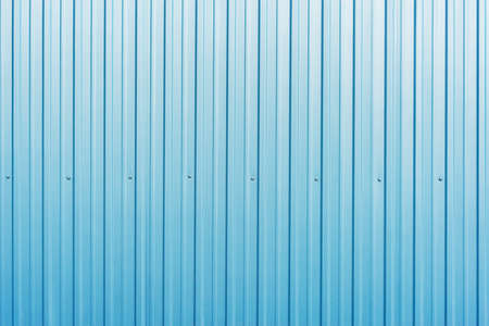 White and blue corrugated metal fence background.の写真素材