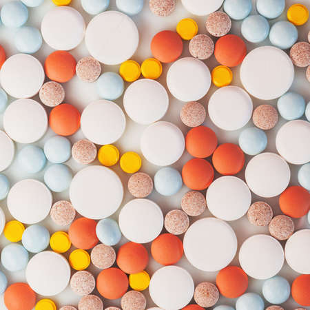 Colorful tablets on the white plate.の写真素材