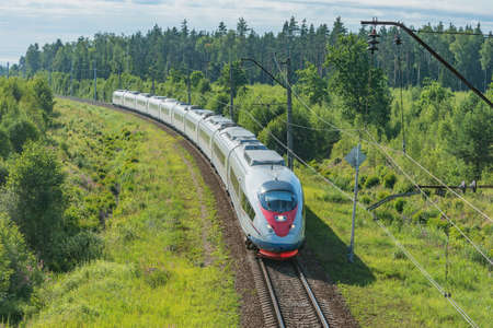 Modern high-speed train moves at summer morning time.の写真素材